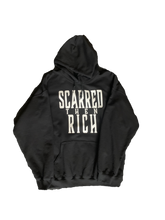 Load image into Gallery viewer, Black sweatshirt with &quot;Scarred then Rich&quot; written in white
